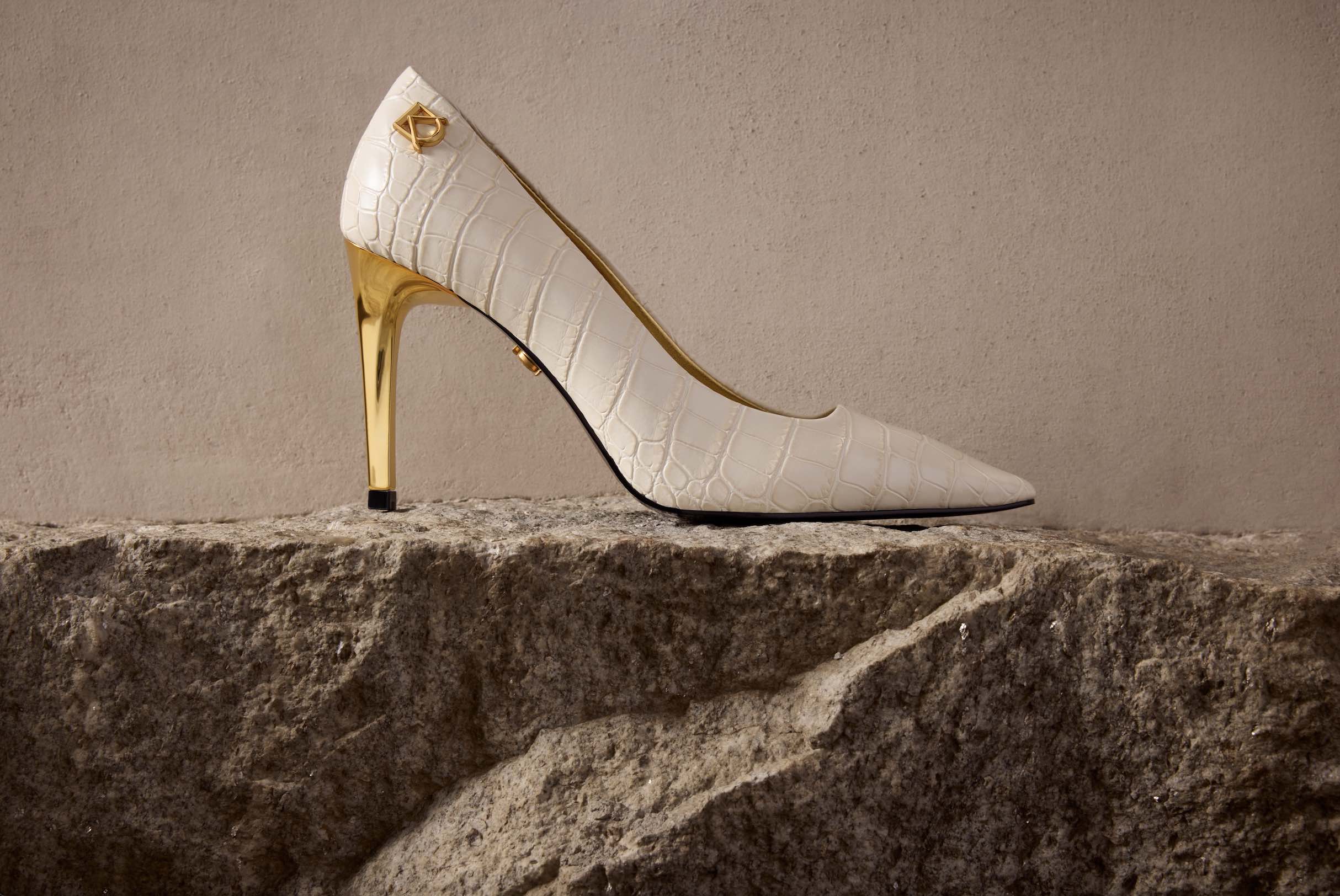 An image of a cream and gold Donna Karan high heel