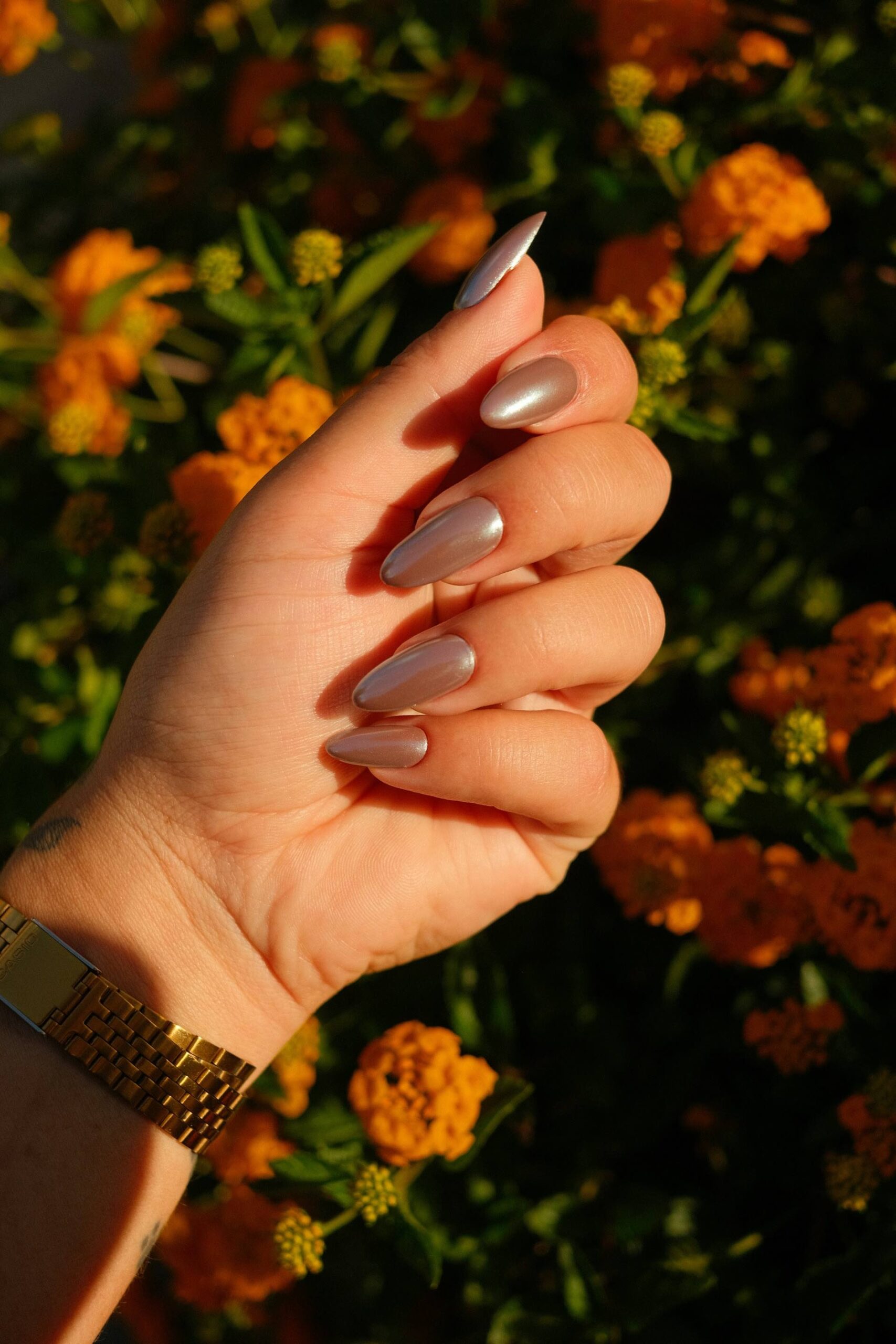 An image of a woman wearing light brown press-on nails