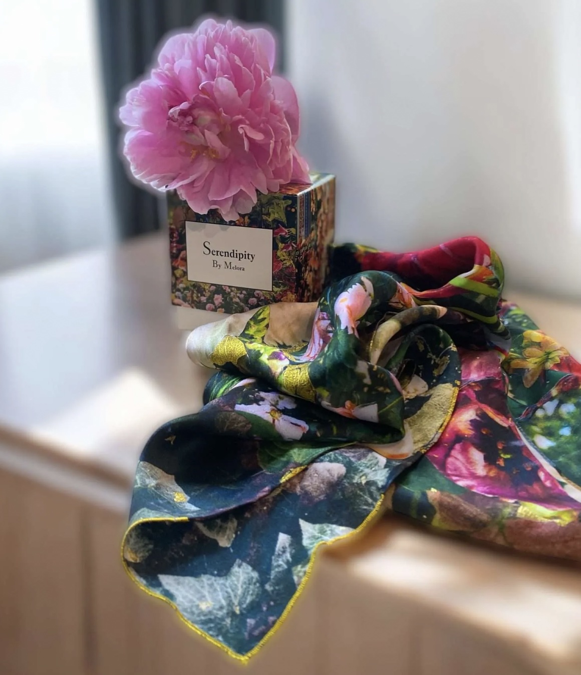 An image of a silk scarf and candle from Melora Hardin.