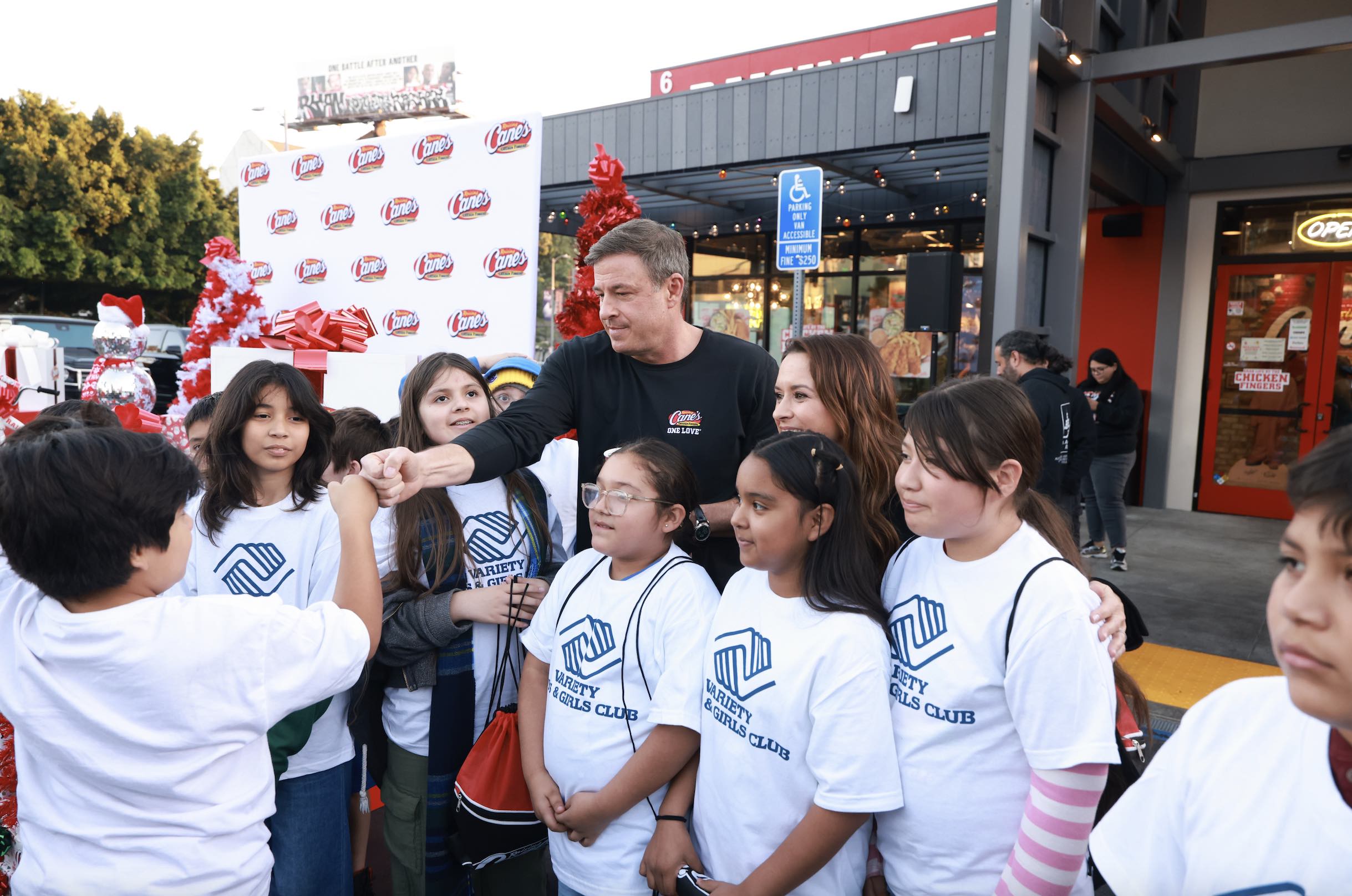 An image of Todd Graves and Lacey Chabert with children from Boys & Girls Club Hollywood.