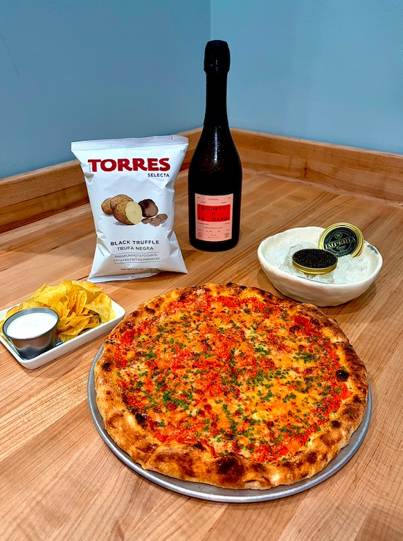An image of pizza, caviar, and champagne from Fiorelli Pizza.