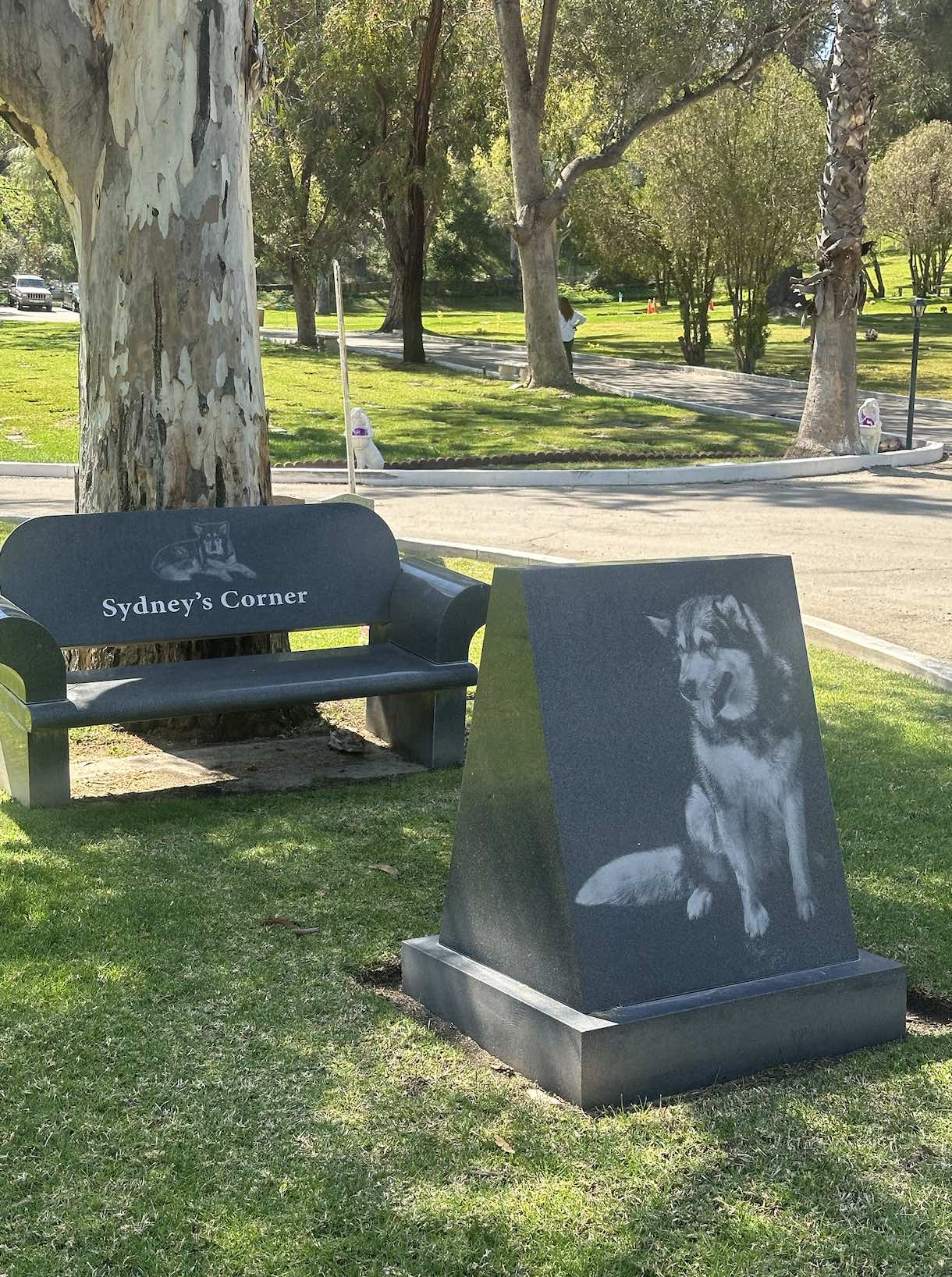 An image of a headstone and bench at the Los Angeles Pet Memorial Park.
