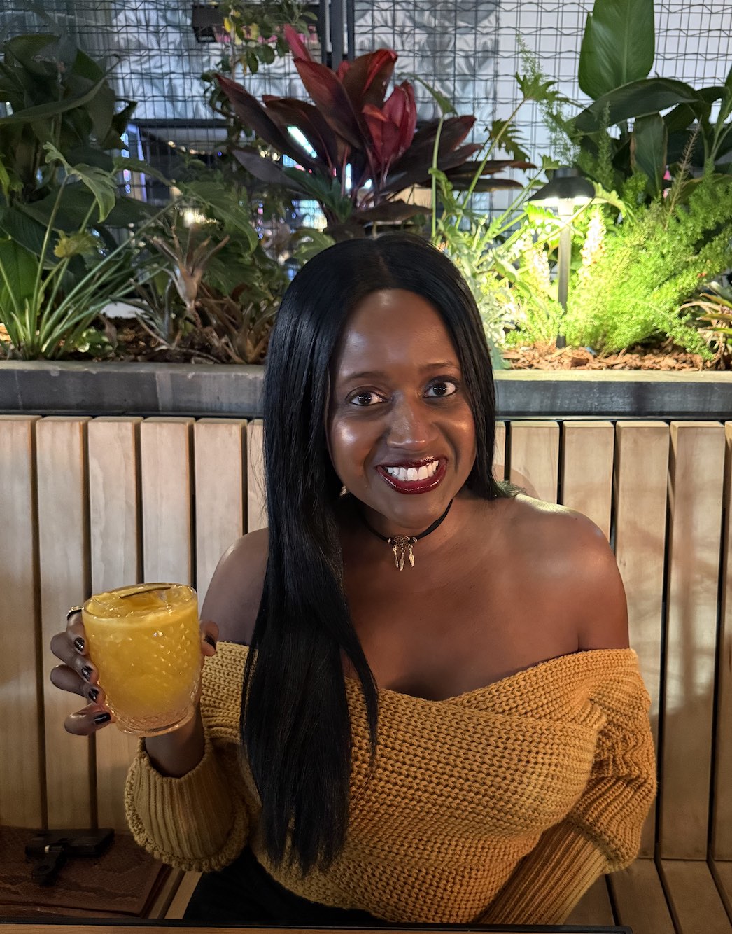 An image of lifestyle blogger Ariel holding a cocktail at La Popular Mexican restaurant.