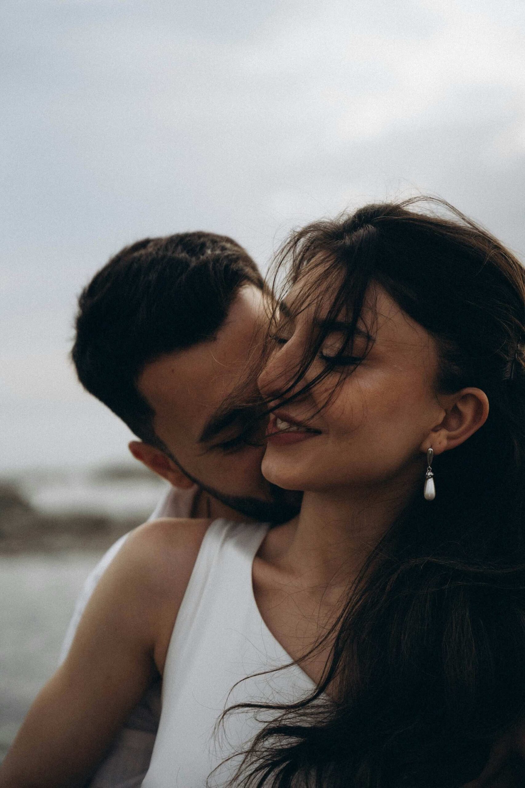 An image of a man kissing a woman's neckl.