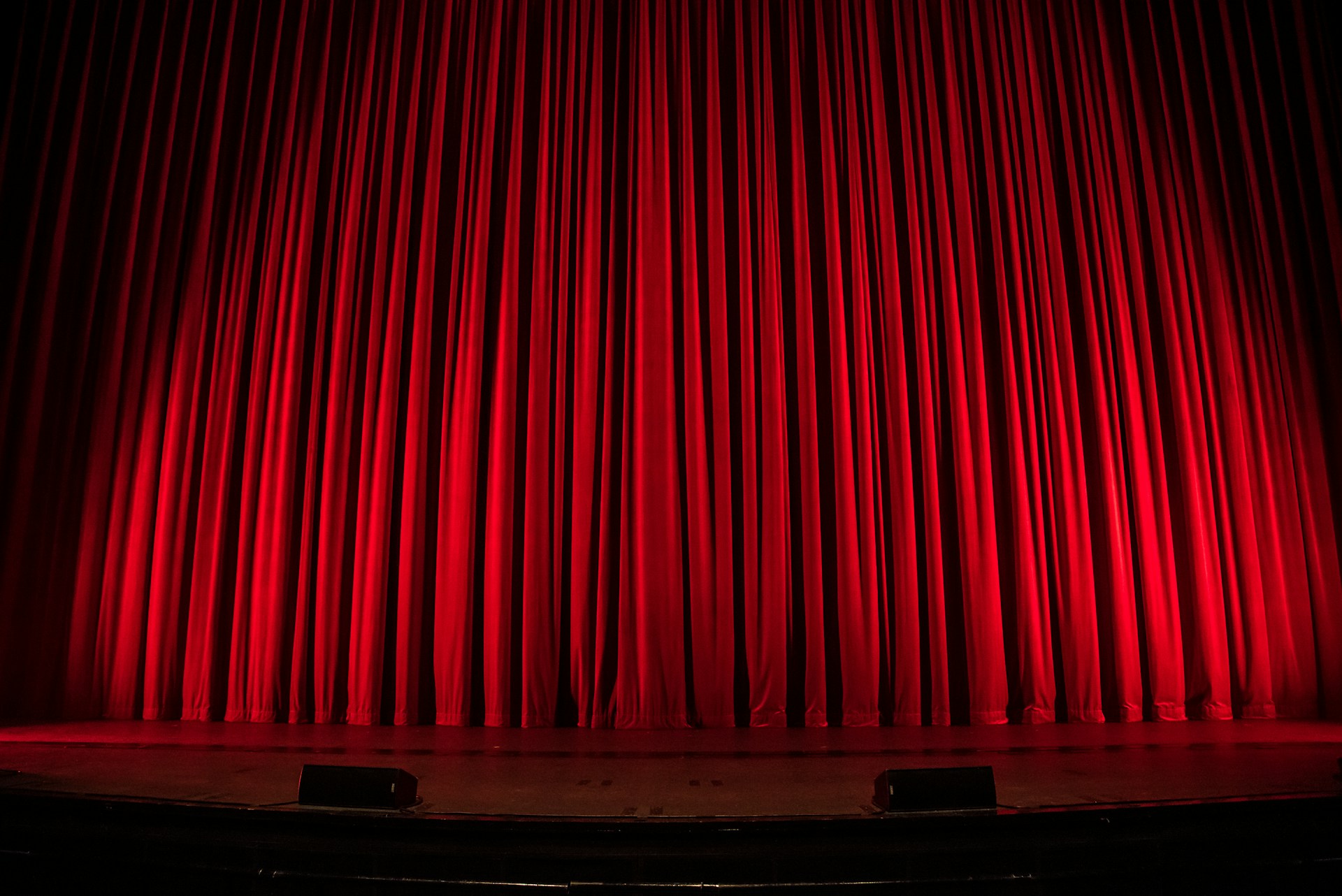 An image of red velvet drapes for an award show.