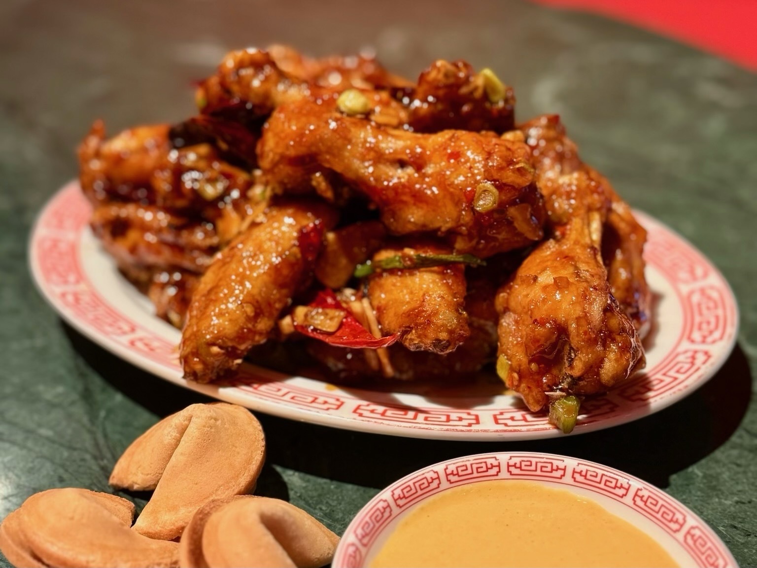 An image of  Genghis Cohen's highly addictive Queen Chicken wings.