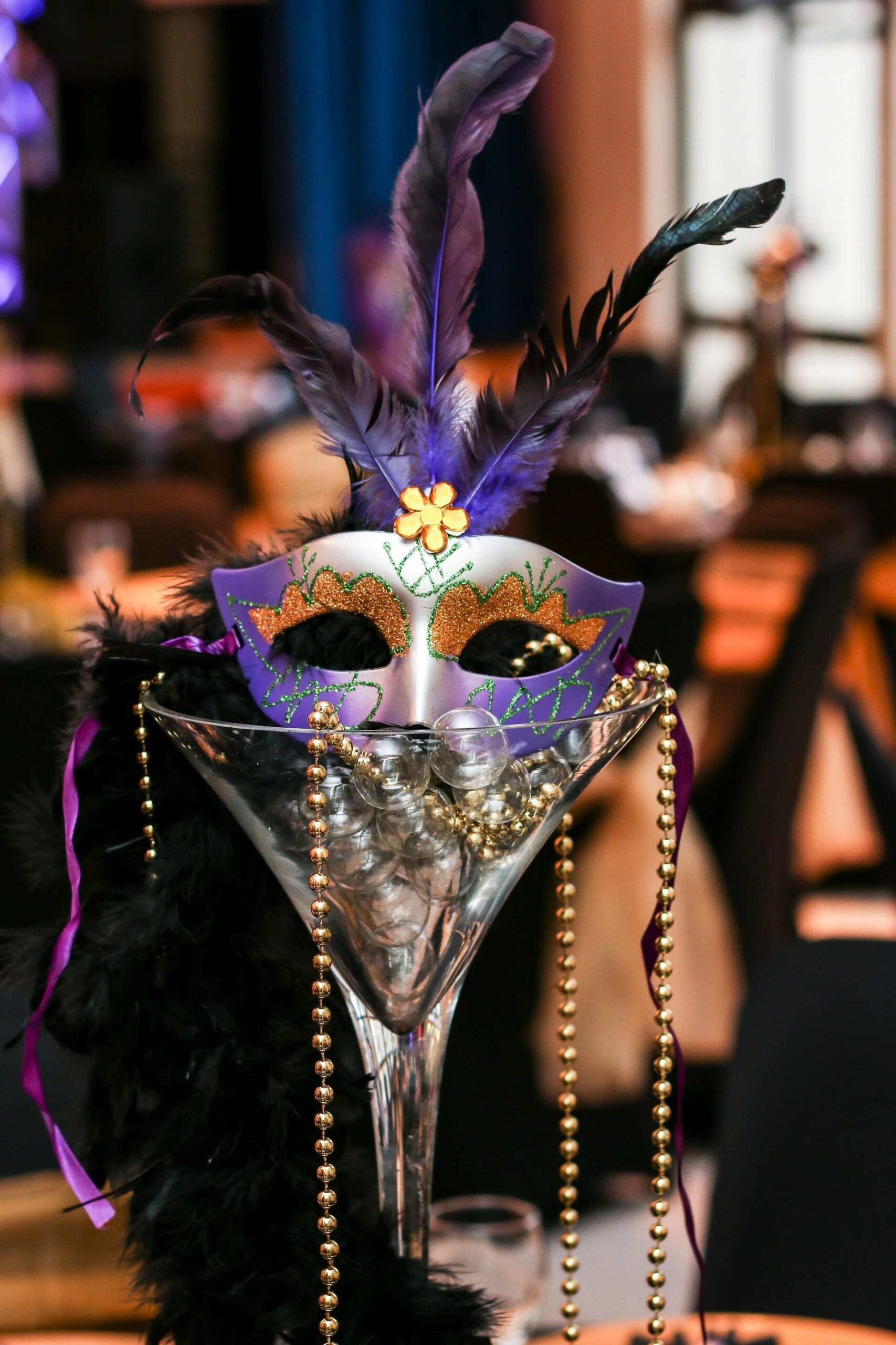 An image of a Mardi Gras mask in a martini glass.
