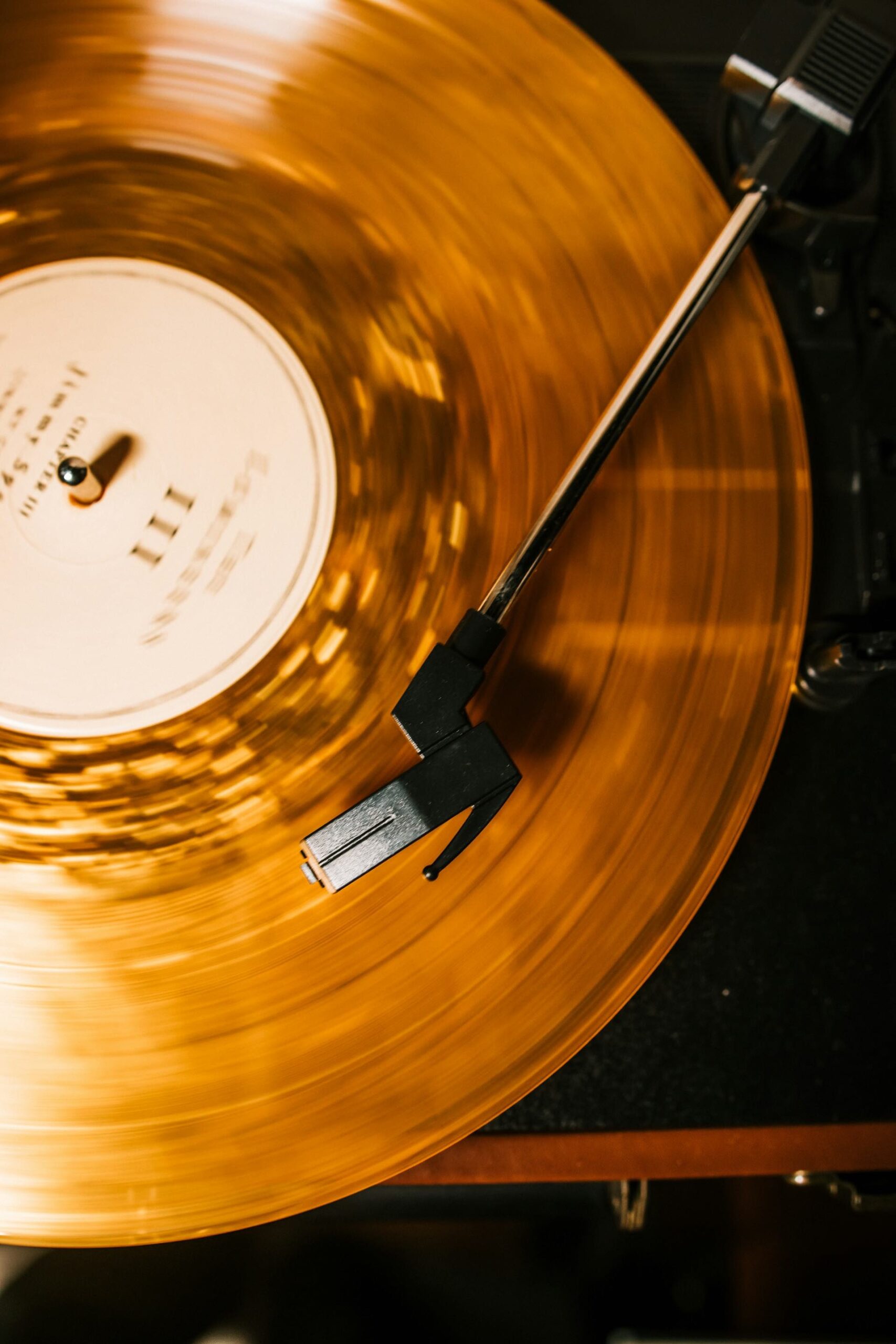 An image of a gold vinyl being played.