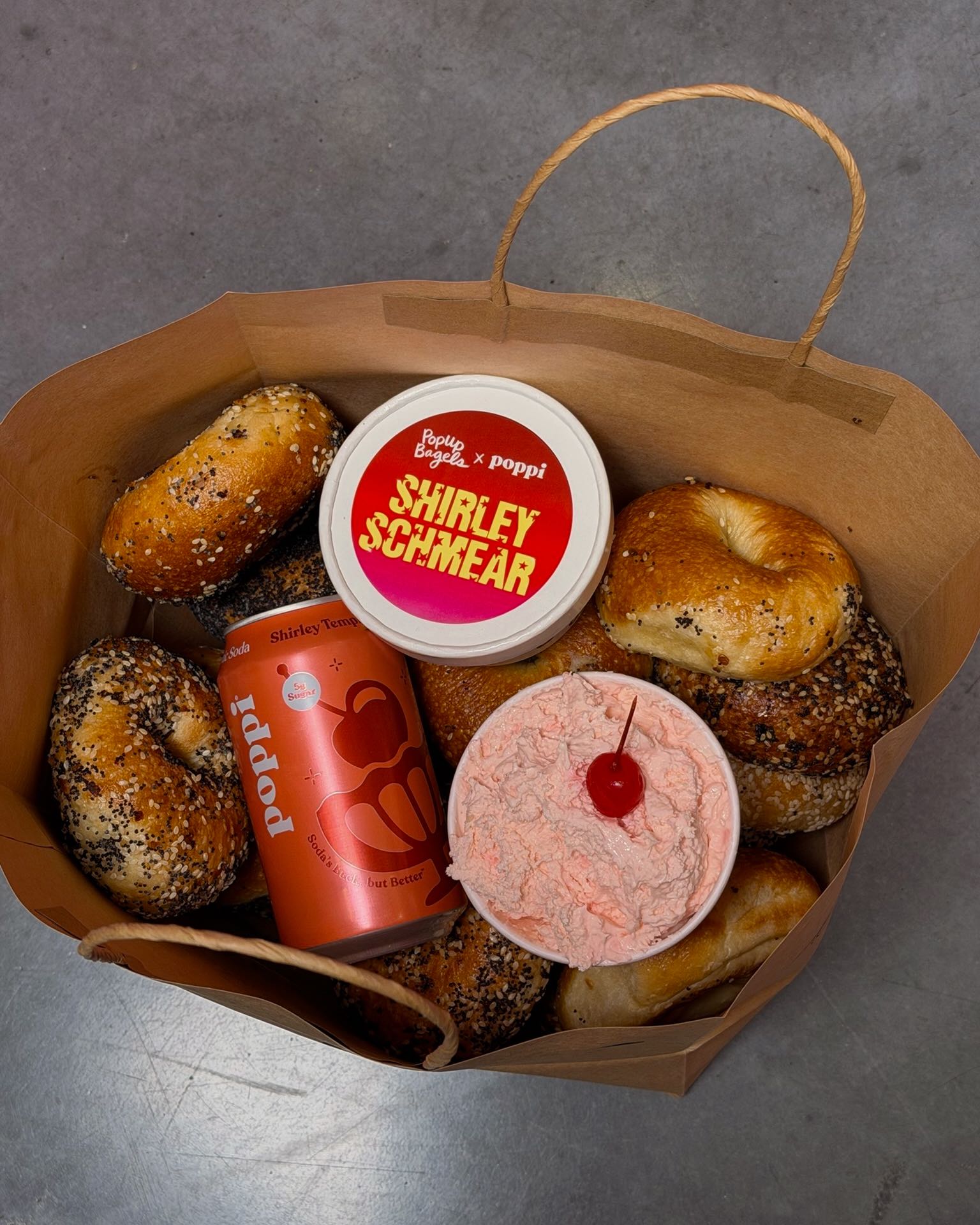 An image of a bag of bagles with poppi and Shirley Temple - inspired cream cheese.