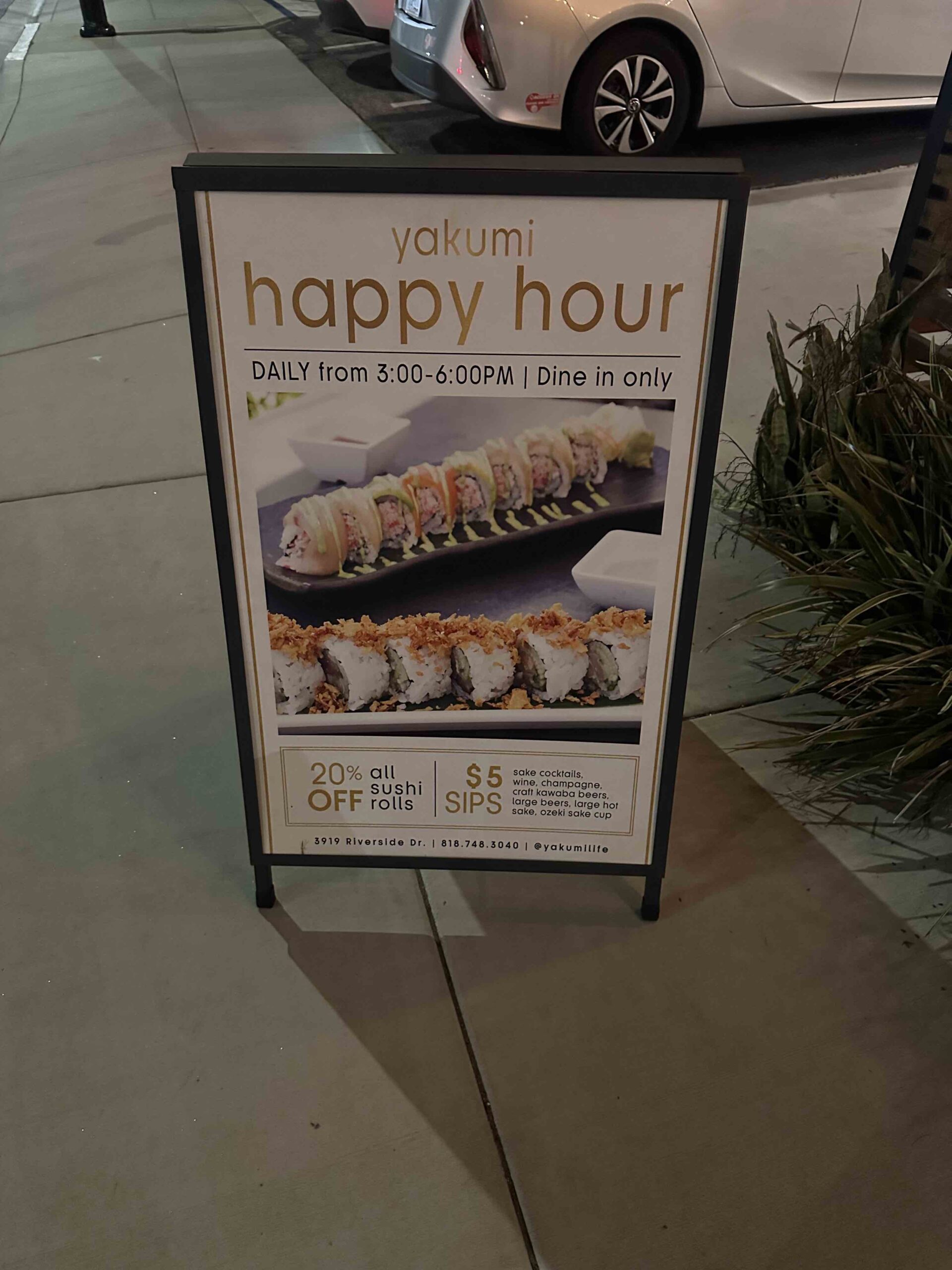 An image of the Happy Hour sign at Yakumi.