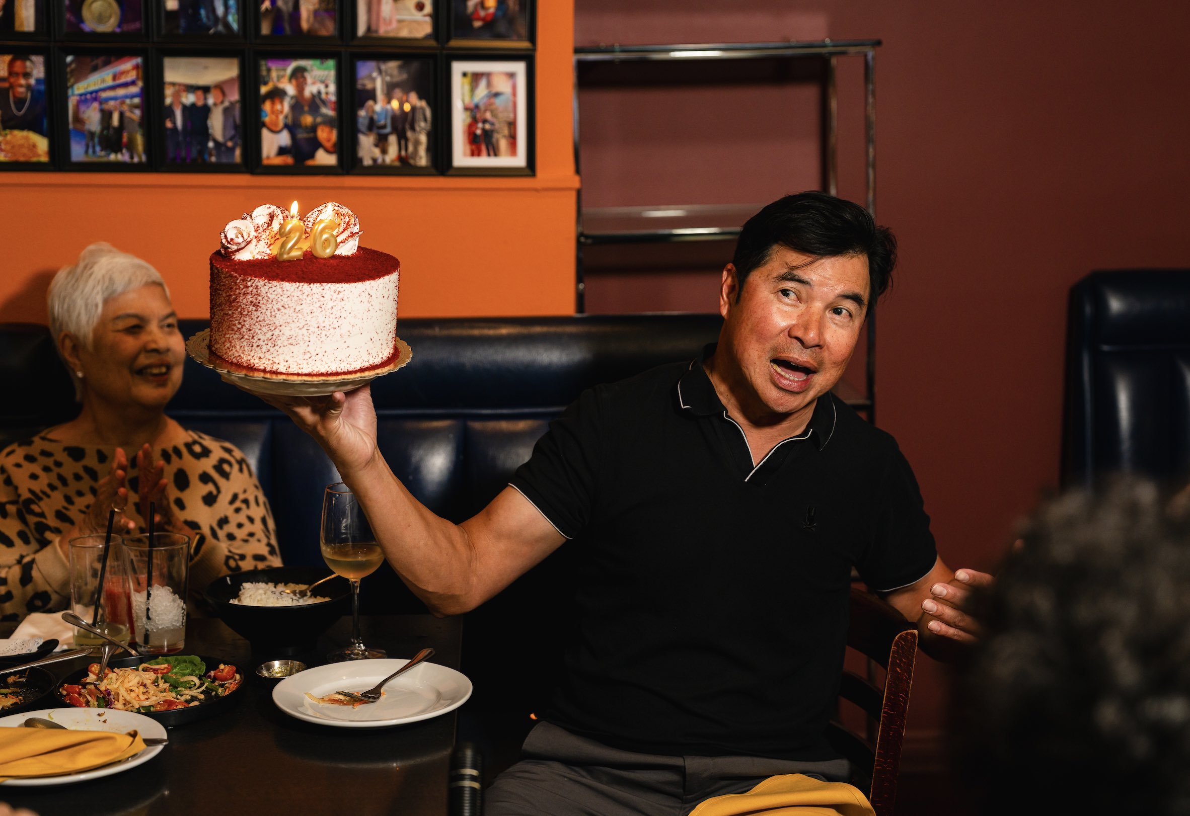 An image of Emporium Thai ower John Sungkamee holding a cake.