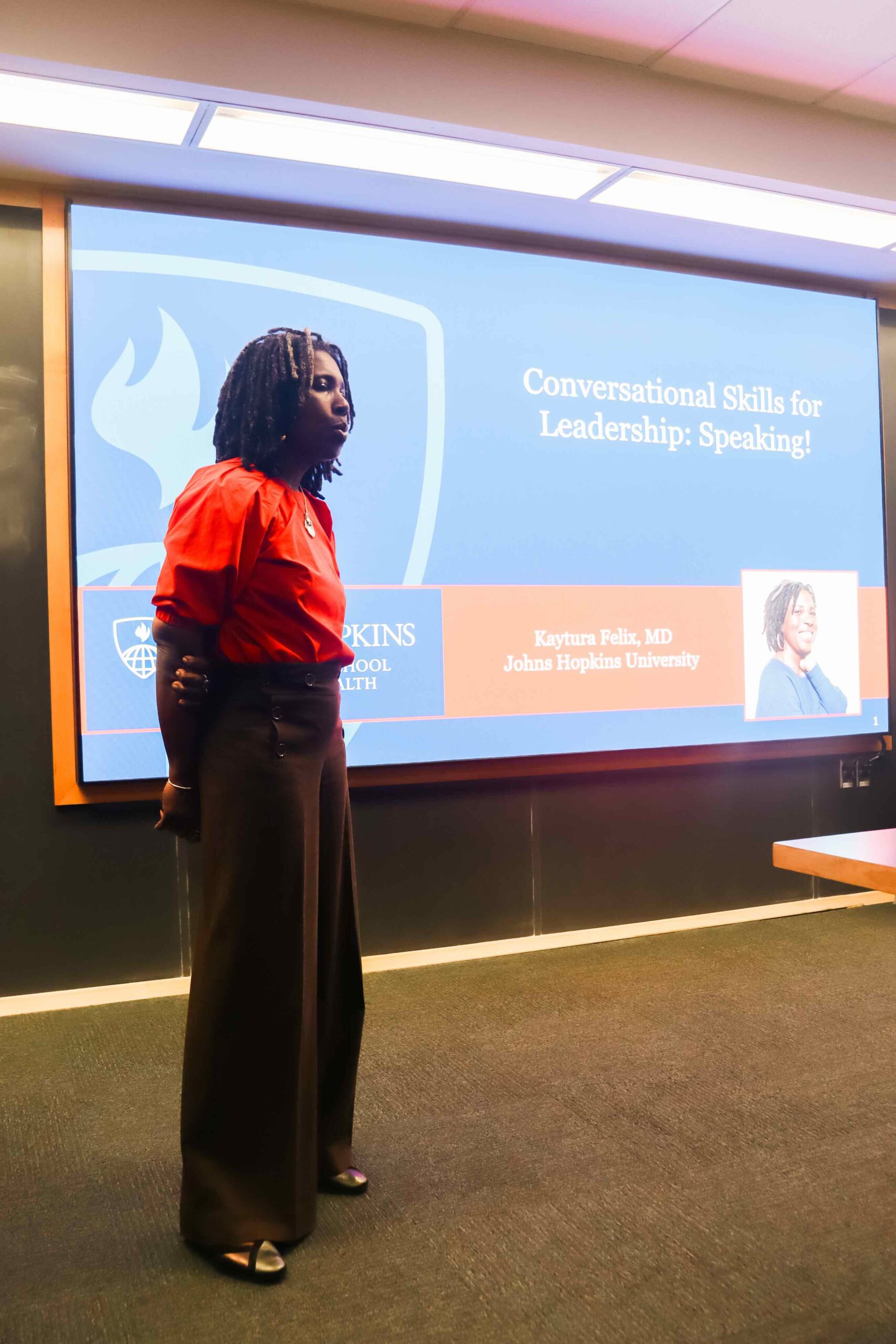 An image of Dr. Kaytura Felix in front of a power point stating her title at Johns Hopkins Bloomberg School of Public Health