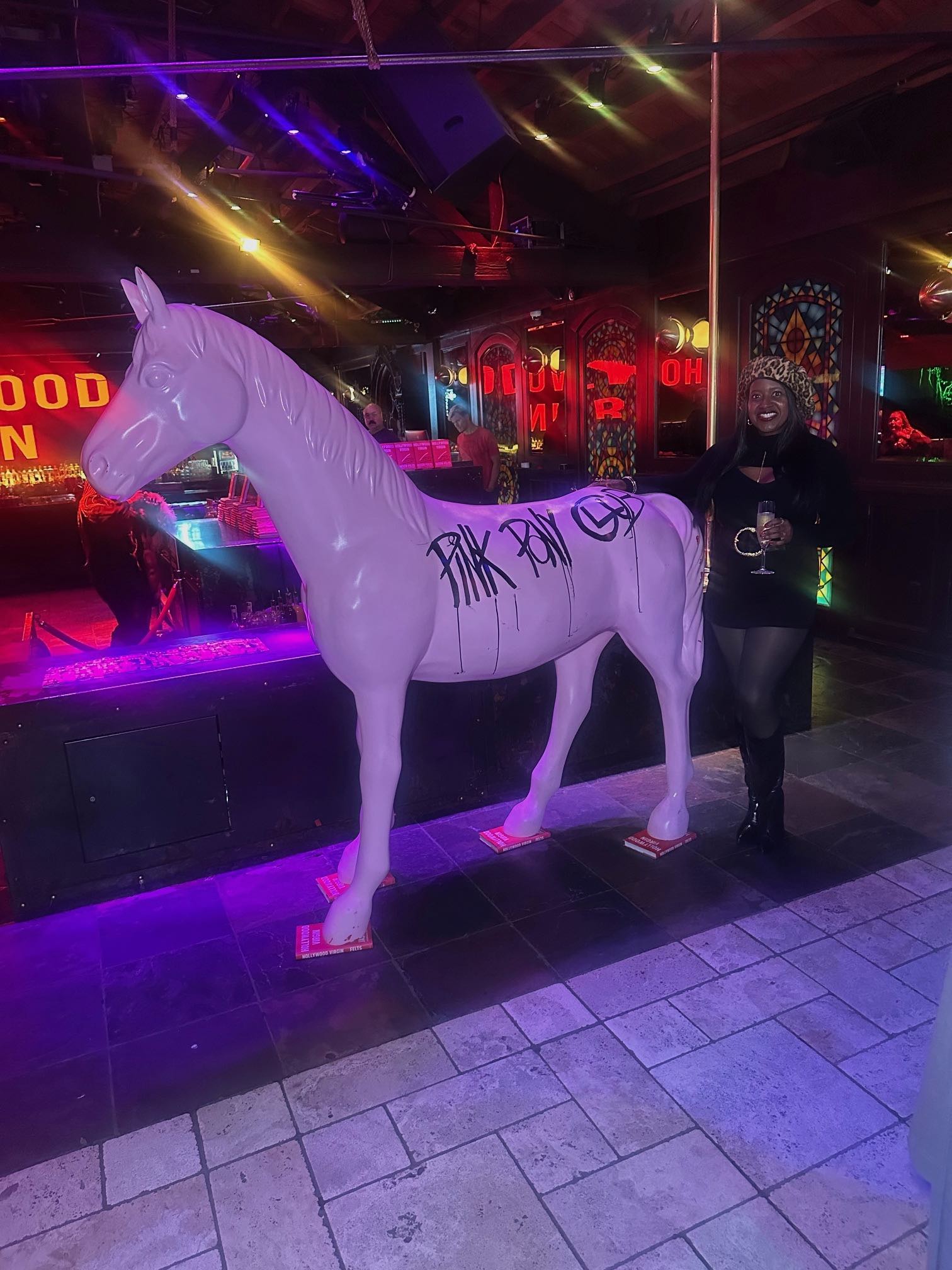 An image of lifestyle blogger Ariel Johns with the pink pony from the Pink Pony Club at The Abbey WeHo