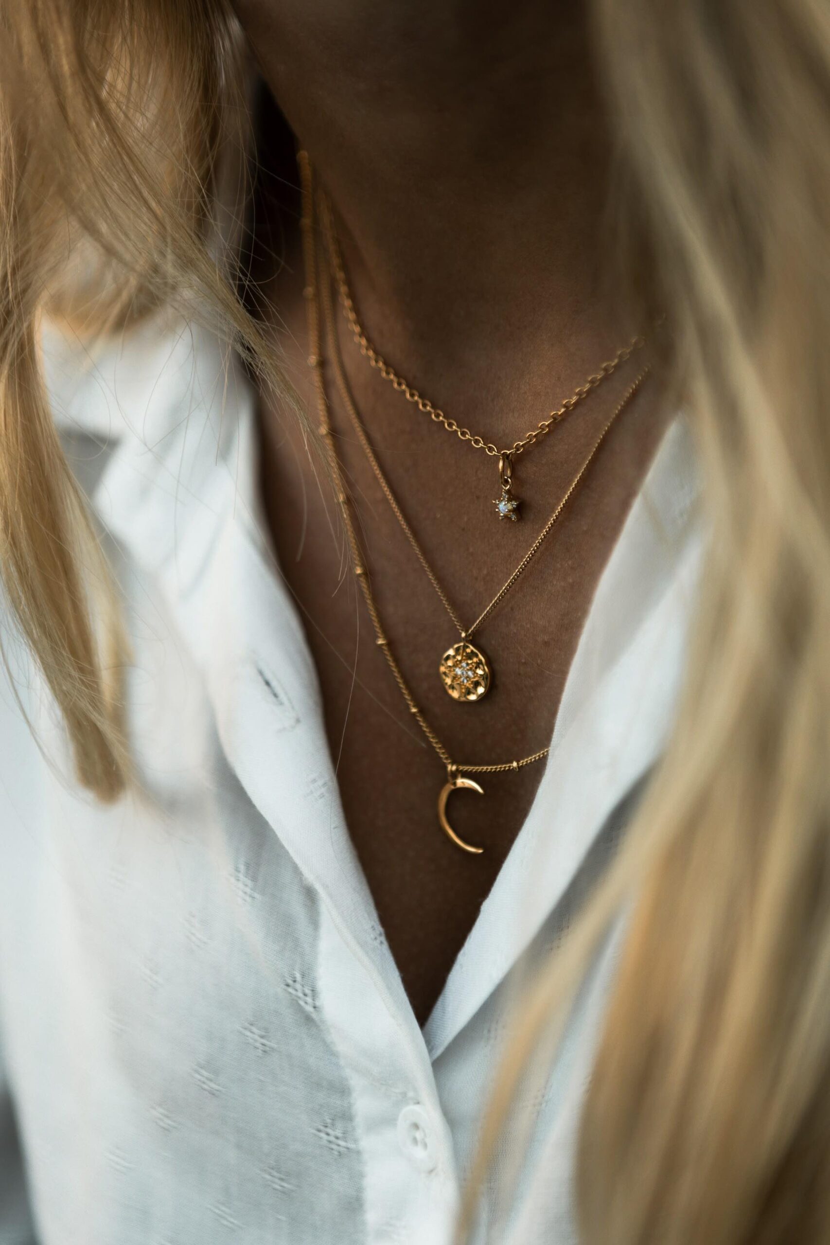 An image of a woman wearing layered necklaces.