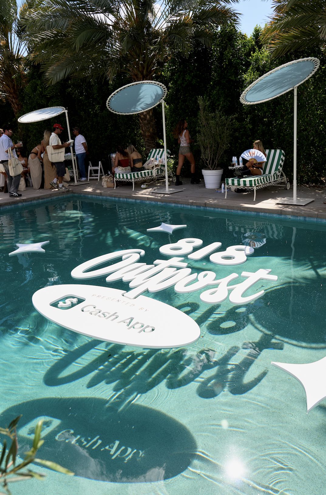 An image of a pool with the sign reading 818 Outpost.