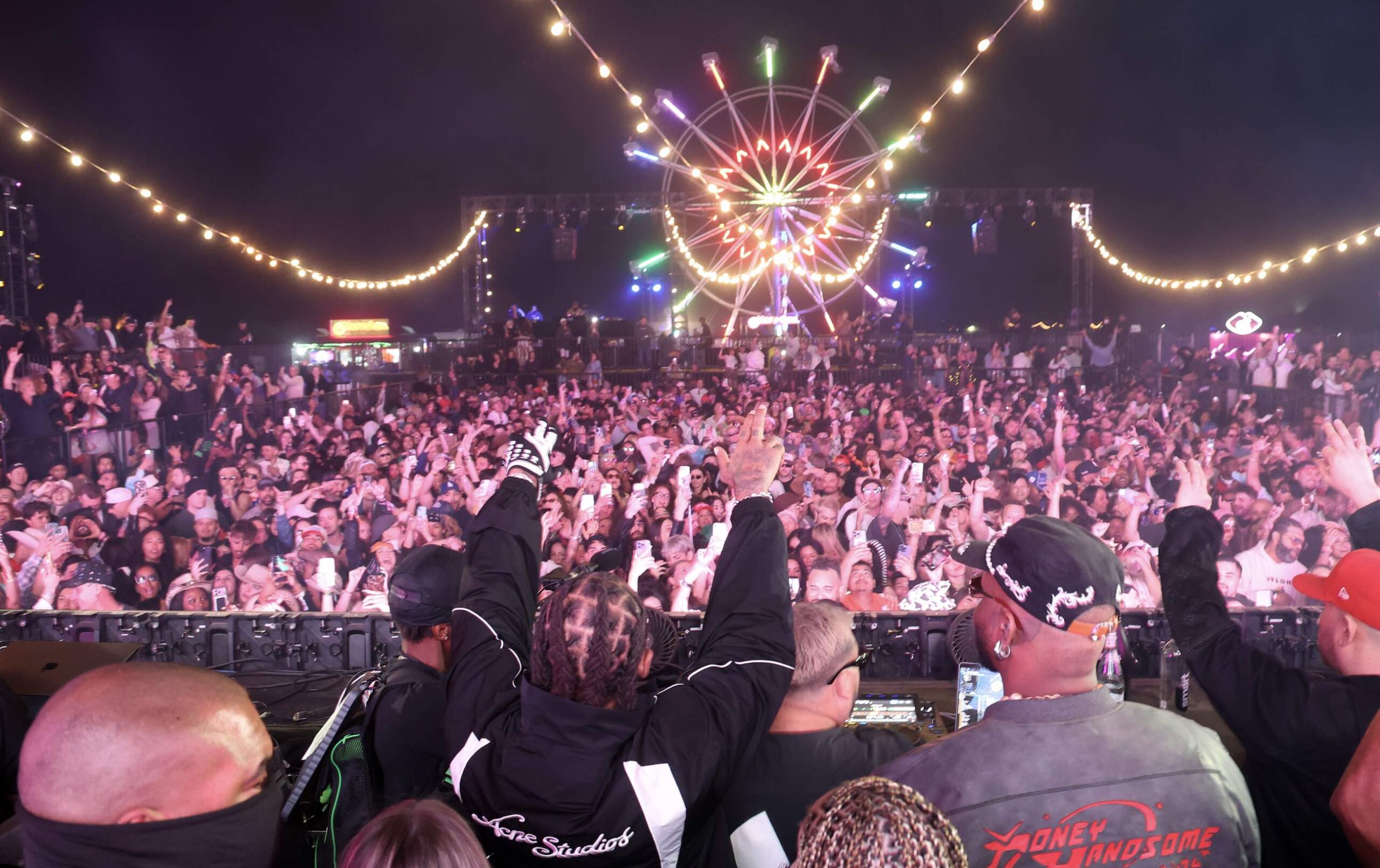 An image of the crowd and ferris wheel at Neon Carnival.