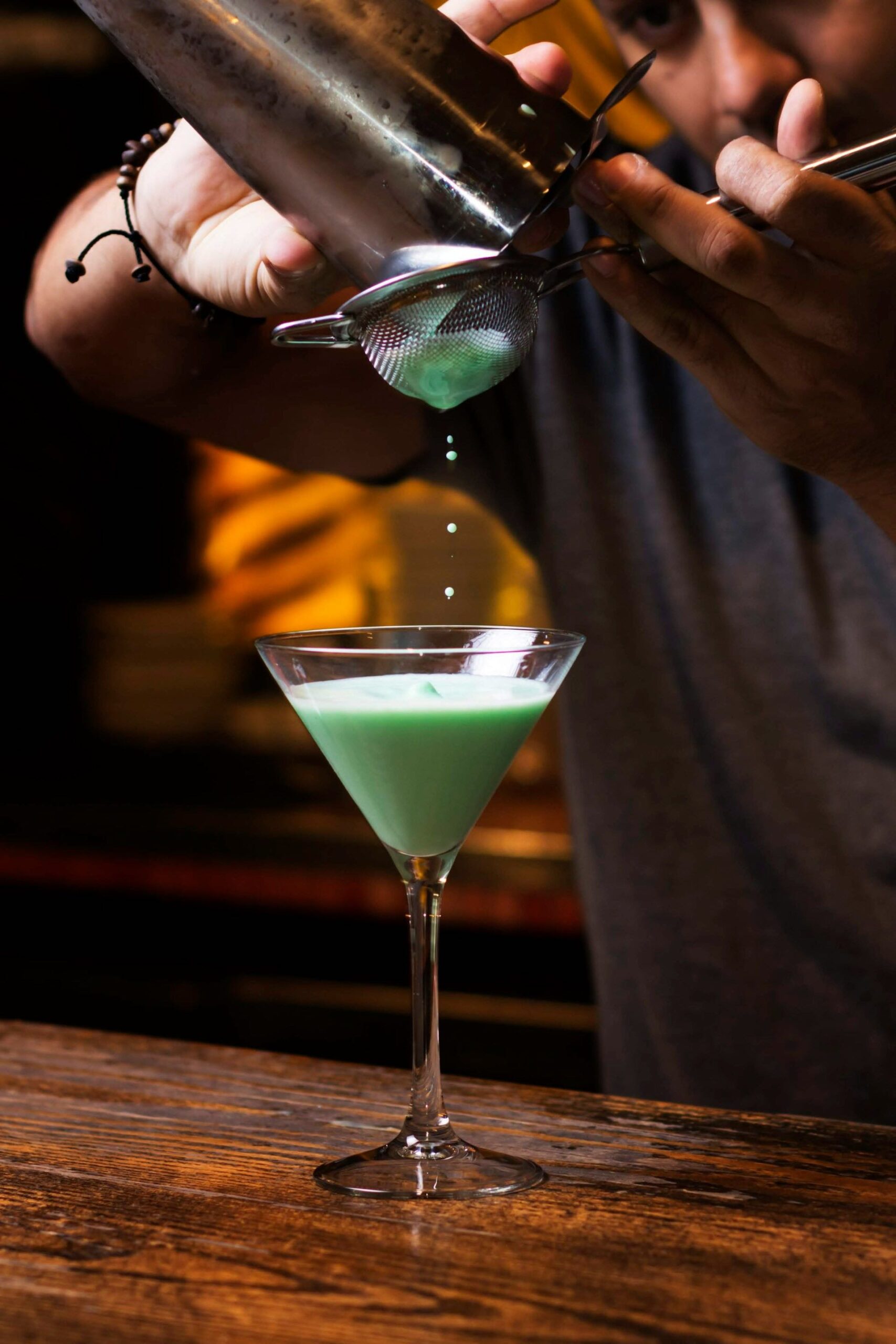 An image of a bartender making a cocktail.