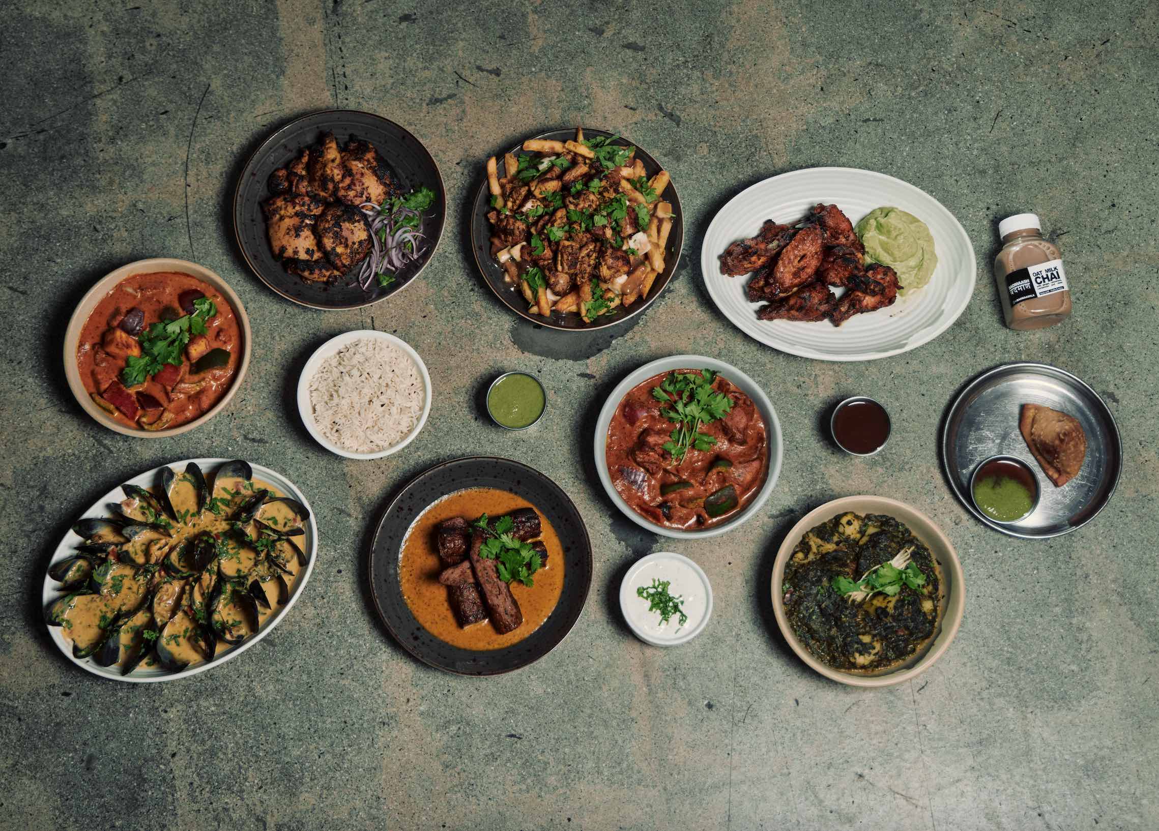 An image of a table covered in food from BADMAASH.