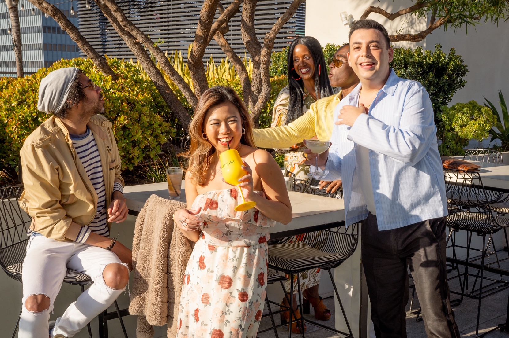An image of a group of people mingling over lite bites at The IO Rooftop at The Godfrey Hollywood.