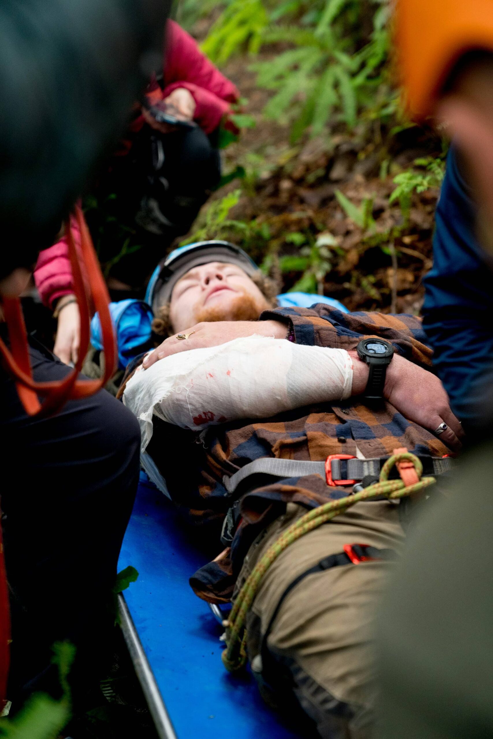 AN image of a man on a stretcher while camping.