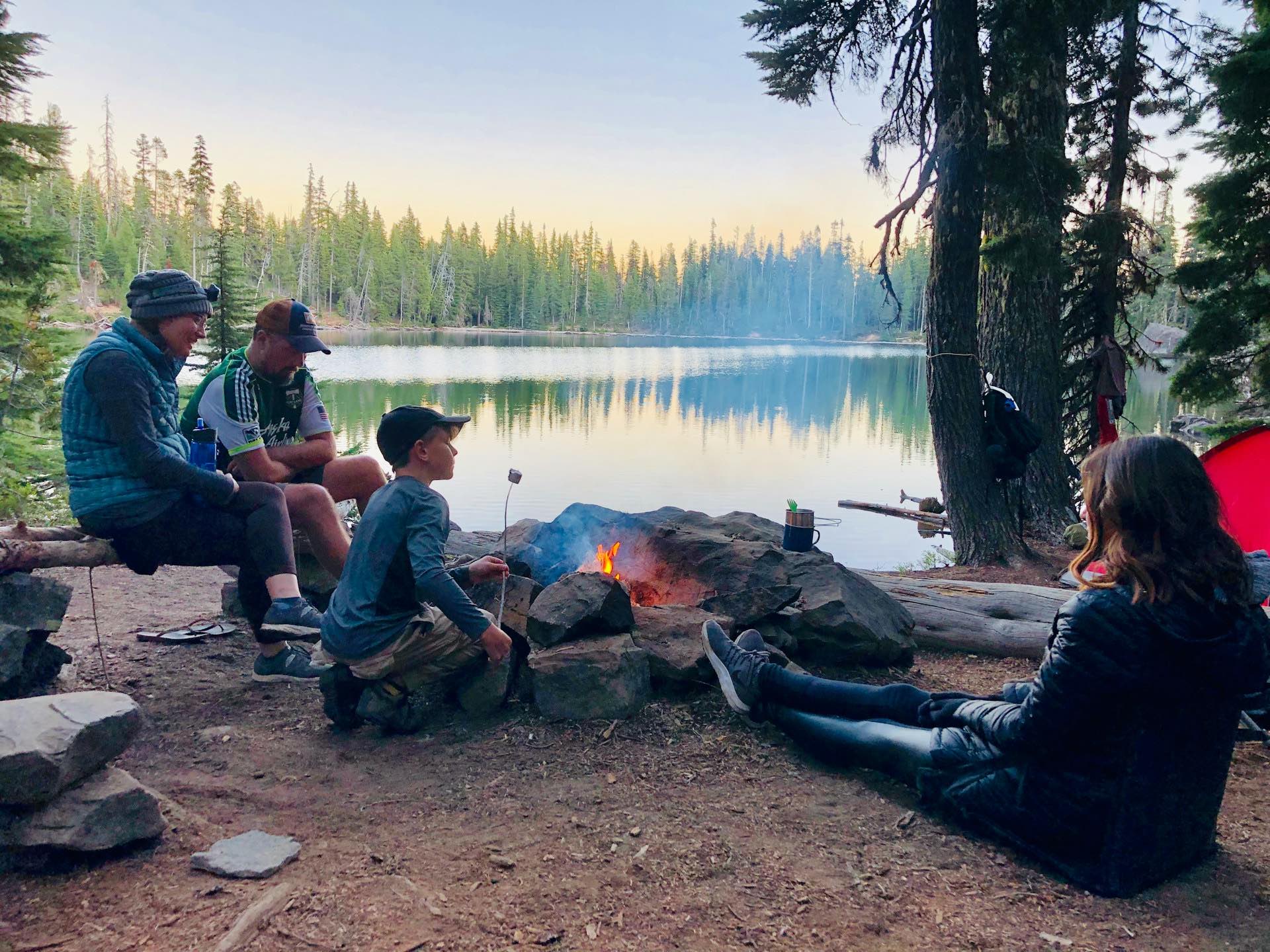 An image of a family eating smores while camping.