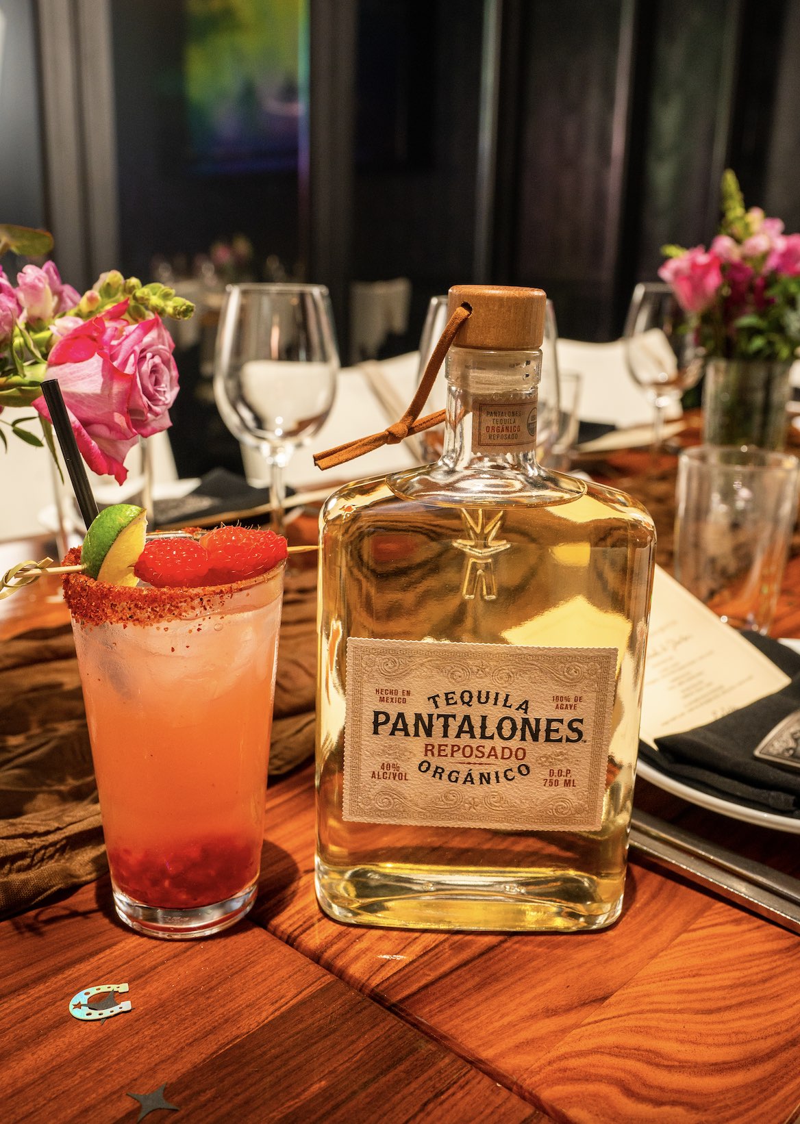 An image of a bottle of Pantalones Tequila next to the Moonlit Ranch Water cocktail.