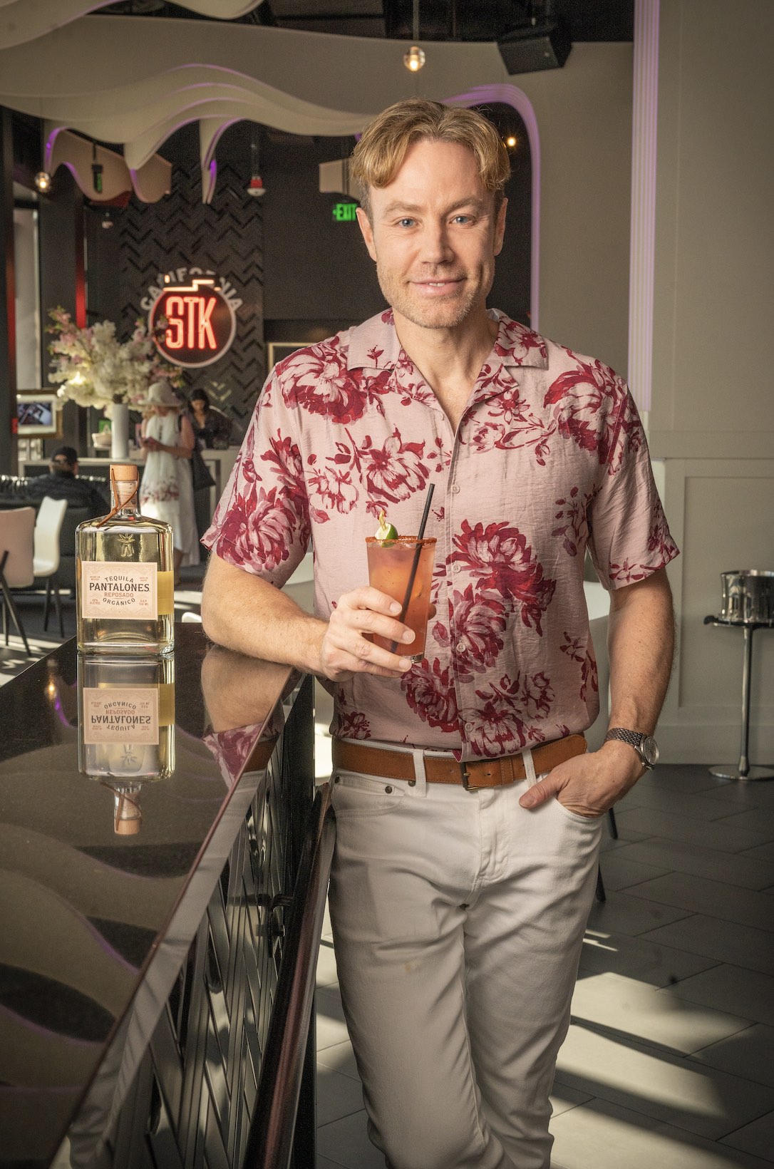 An image of Paul Zahn holding his Moonlit Ranch Water next to a bottle of Pantalones Tequila.