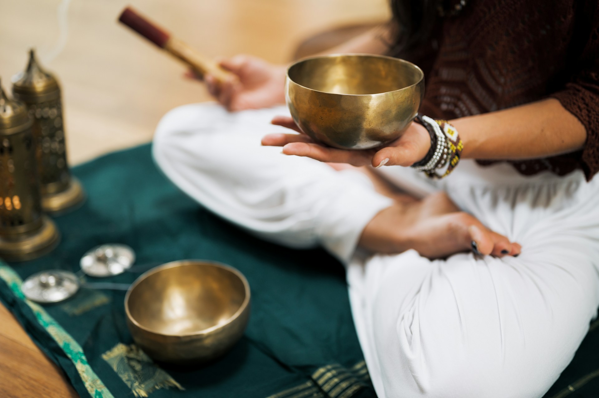 AN image of a sound healer with sound bowls.