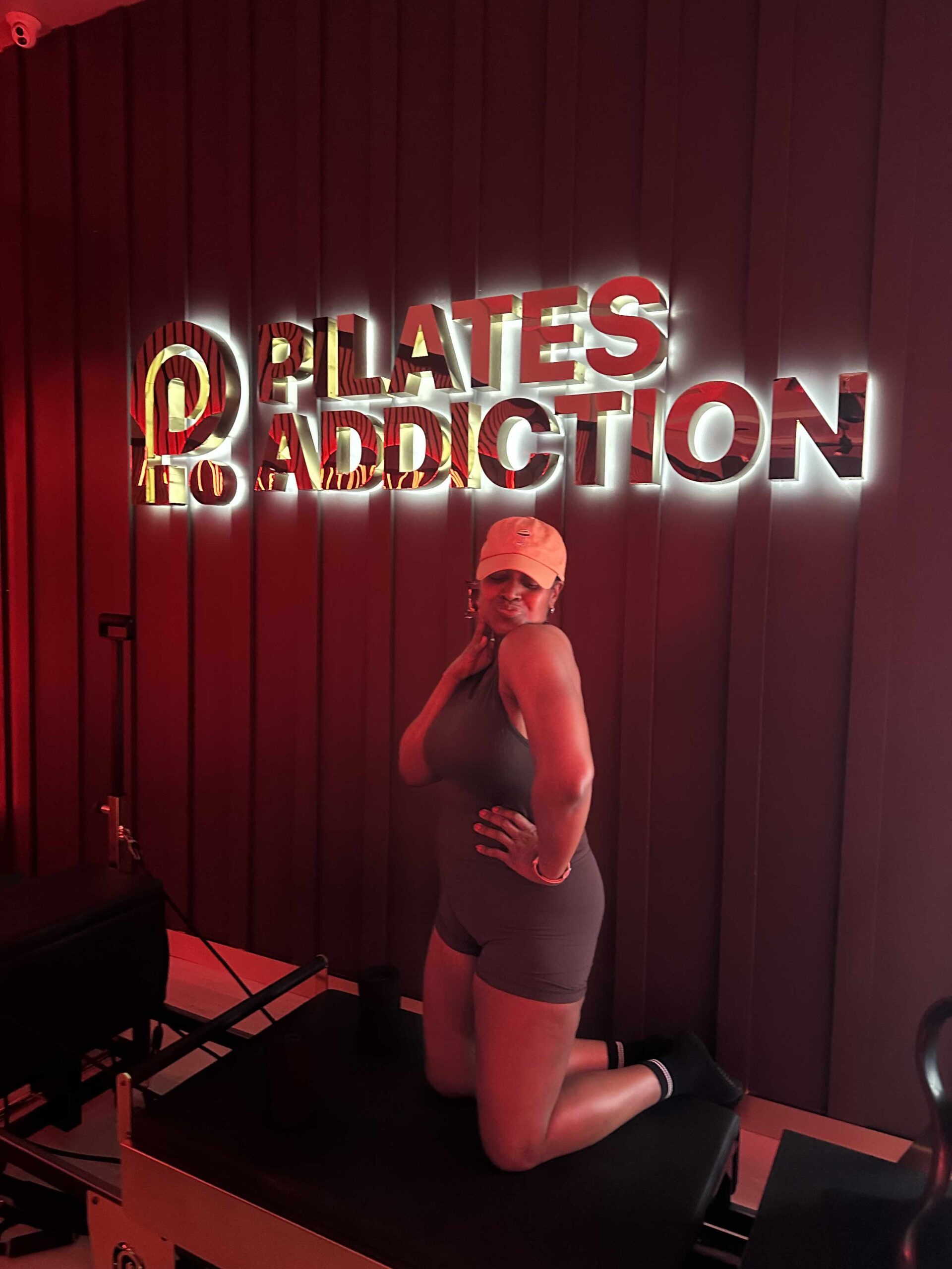 An image of lifestyle blogger Ariel Johns on the Pilates machine at Pilates Addiction. 