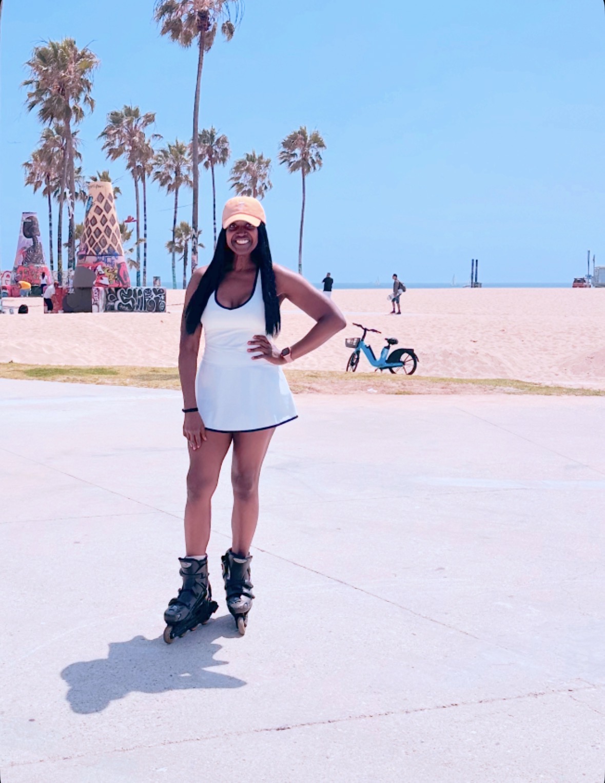 AN image of lifestyle blogger Ariel Johns on rollerblades at Santa Monica Beach.