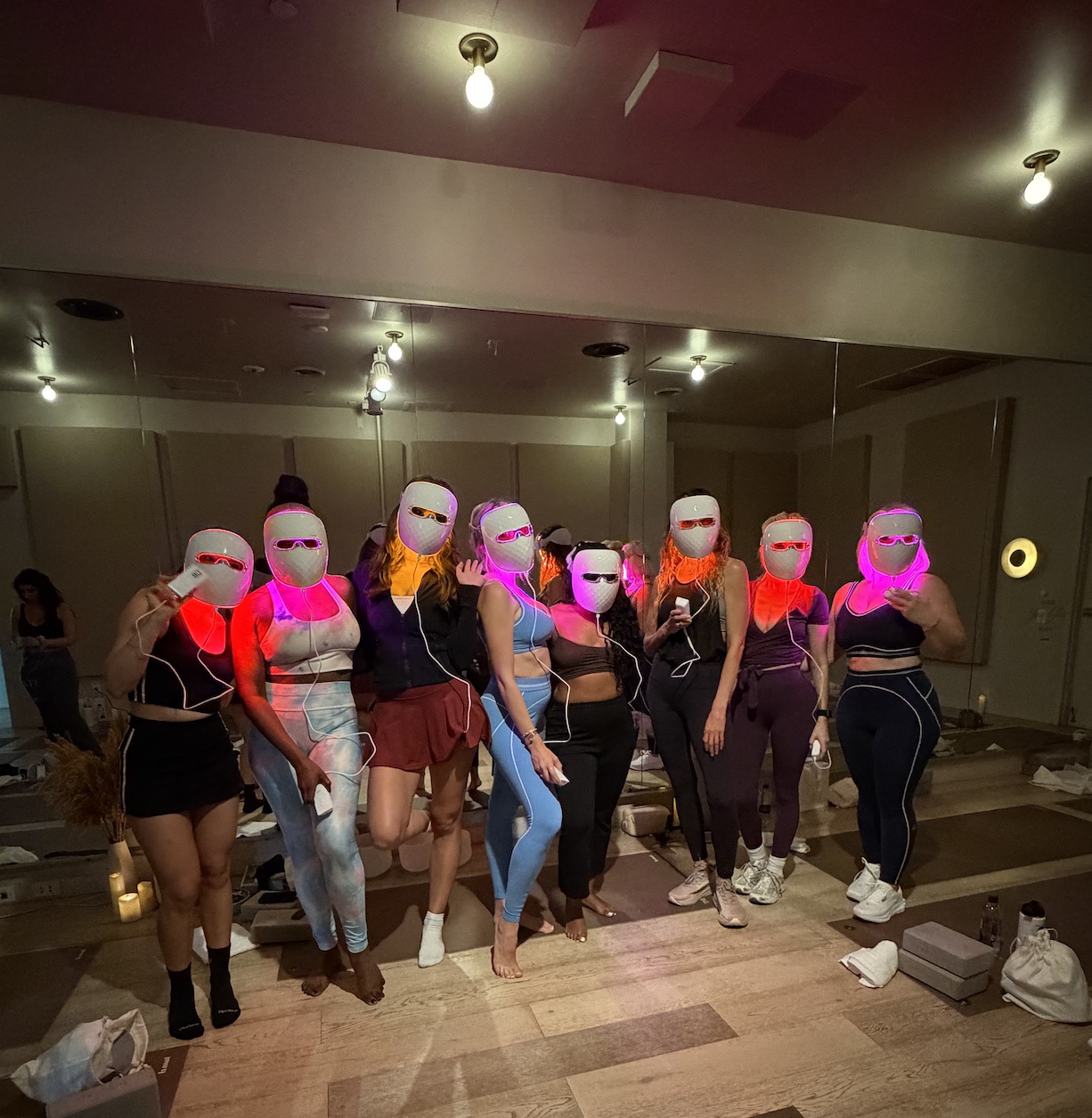 An image of a group of bloggers wearing Ulike's Red Light Therapy Mask after a workout at The Class.