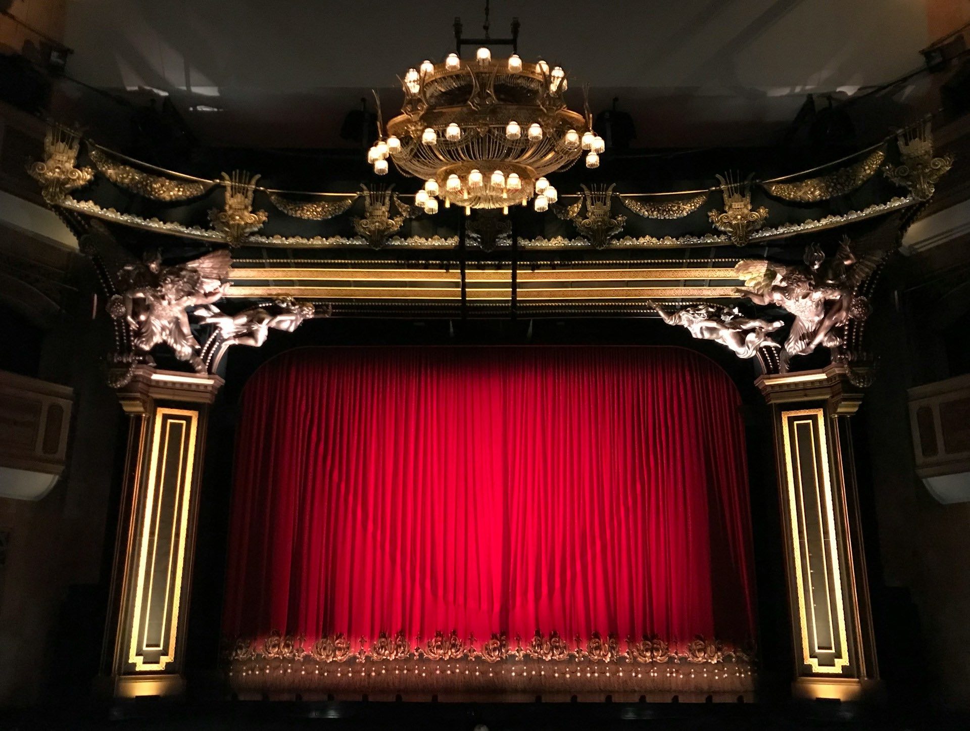 An image of a theatre and the red curtain.