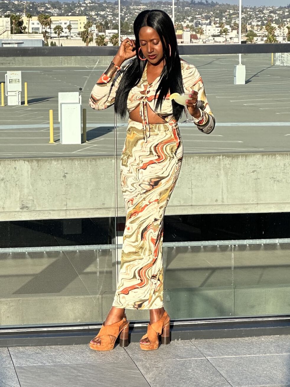 An image of lifestyle blogger Ariel Johns in a white long fitted dress.