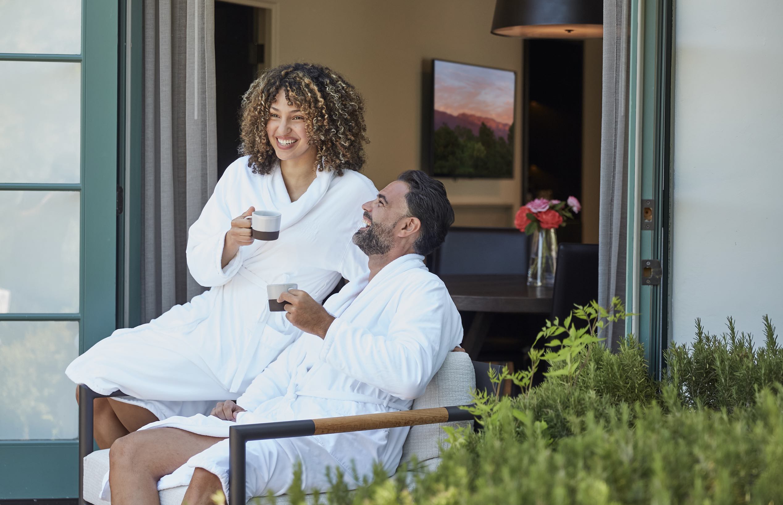 An image of a couple in bathrobes and drinking coffee at the Ojai Valley Inn
