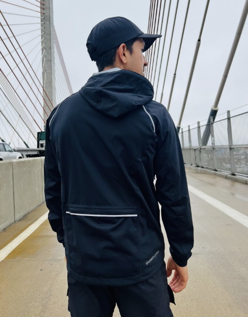 An image of a man wearing a Showers Pass Cloudburst Hoodie
