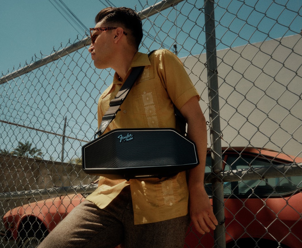 An image of a man wearing a ROCKSTER CROSS heavy-duty Bluetooth speaker