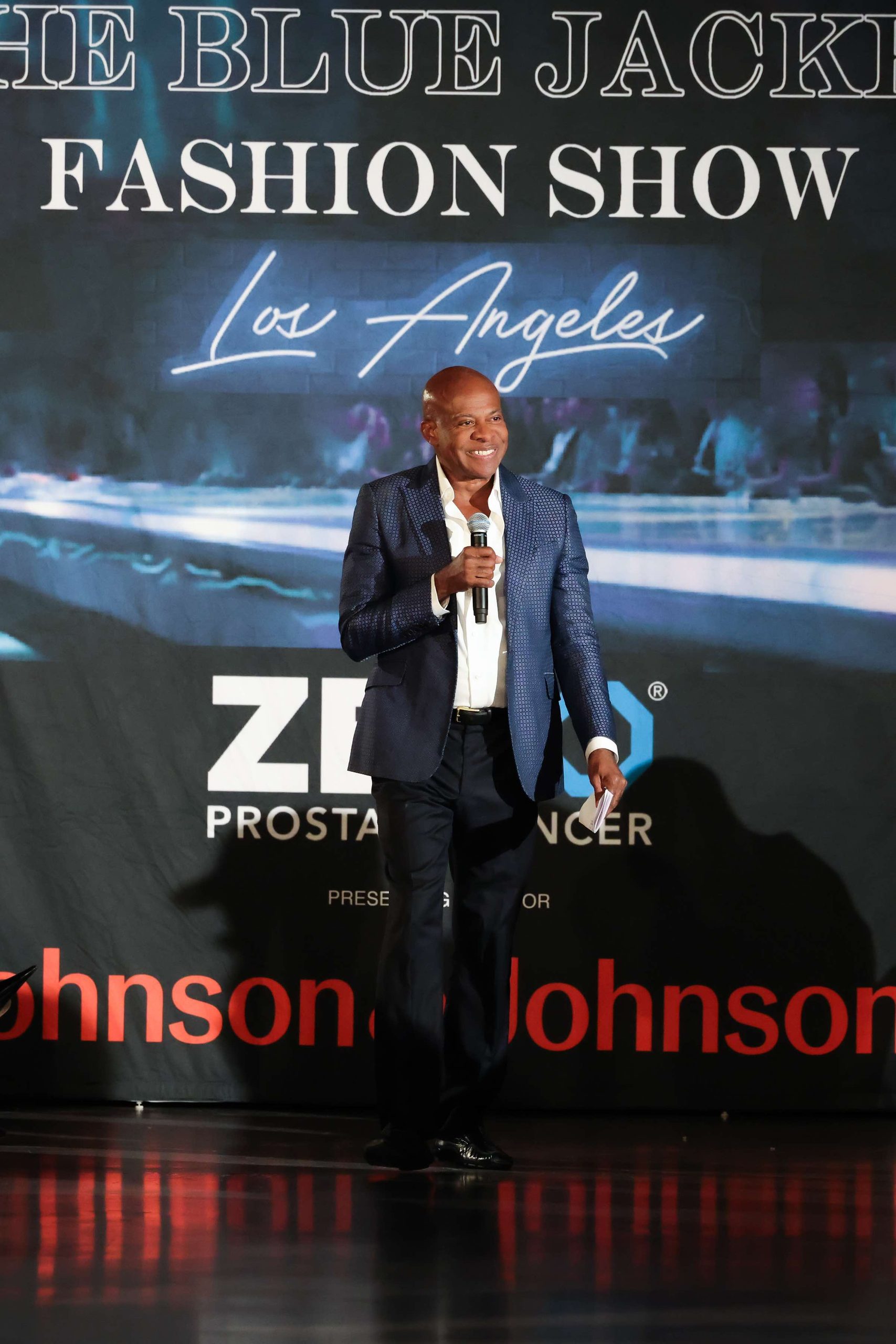 An image of Acclaimed designer Frederick Anderson kicking off the evening by welcoming guests to the Blue Jacket Fashion Show. 